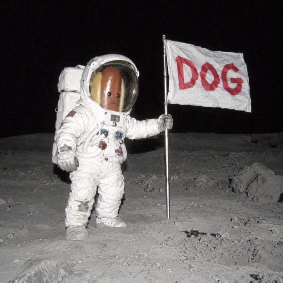 A hot dog astronaut on the moon planting a flag