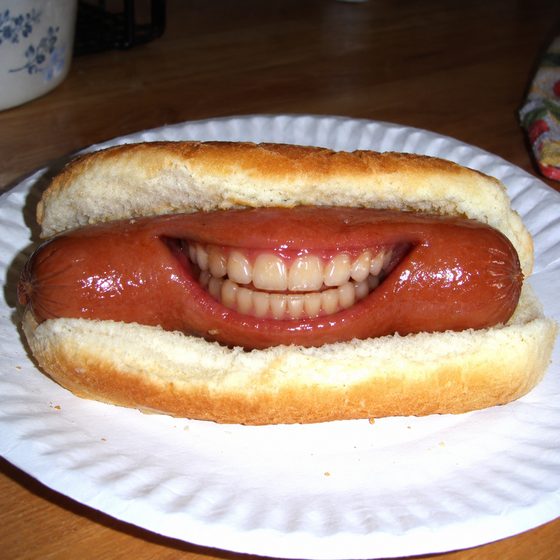 A hot dog with a human smile full of teeth